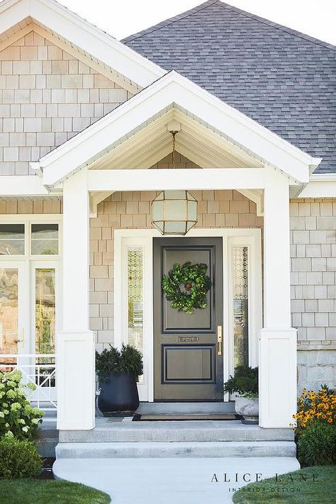 Suzanne Kasler Morris Lantern fitted above a black front door in a covered porch with a black border doormat and styled potted plants. Portico Entry, Portico Design, House Front Porch, Porch Remodel, Black Front Doors, Farmhouse Front Door, Metal House Numbers, Front Porch Design, Address Signs