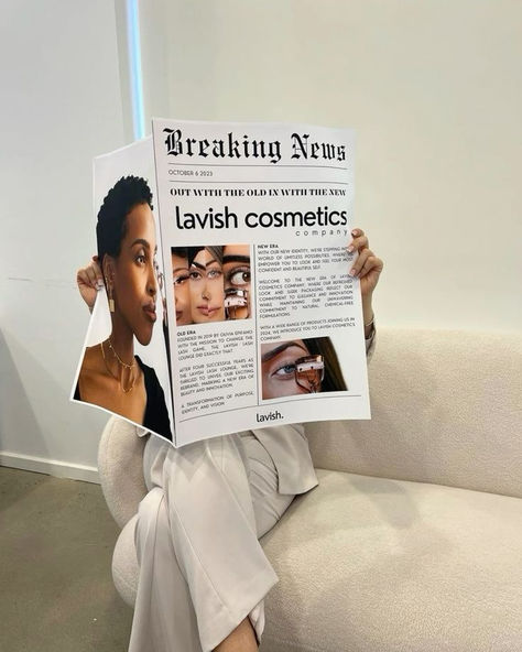 A person sitting on a modern couch holding a newspaper featuring bold headlines about 'lavish cosmetics' with images of diverse beauty models. This cosmetics branding mockup provides inspiration for innovative, editorial-style photoshoots, perfect for graphic designers and businesses looking to create fresh, impactful visuals for brand promotions. Business Owner Photoshoot, Newspaper Mockup, Honeymoon Nails, Cosmetics Branding, Cosmetics Company, Salon Suites, Business Photoshoot, Branding Photoshoot Inspiration, Aesthetic Content