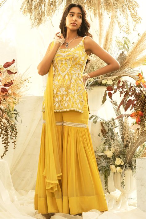 Featuring a yellow kurta in crepe and organza base with embellishments and embroidery. It is paired with matching sharara pants and a dupatta.  FIT: Fitted at bust and waist. COMPOSITION: Crepe, Organza. CARE: Dry clean only. Yellow Sharara For Haldi, Dress For Mehendi Function, Organza Sharara, Yellow Sharara, Haldi Dress, Sleeveless Kurta, Sharara Designs, Haldi Outfits, Sleevless Dress