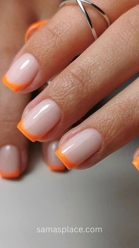 Elegant hand showing off a minimalist nail design with a sheer nude base and bright orange borders on a set of oval nails. Acrylic Nails Neon Orange, Neon Orange French Tips, Orange French Tips, Acrylic Nails Neon, June Nails Ideas, Acrylic Nail Designs Classy, Neon Orange Nails, June Nails, Nail Courses