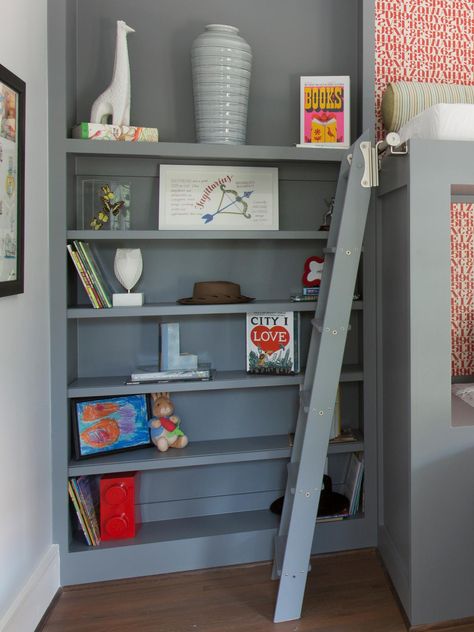 For this boys' bedroom, a gray laminate bookcase allows childhood items to be displayed and stored when not in use. The bookcase was constructed from the same material as the bunk bed and ladder for a coordinated look. Built In Loft, Kids Coastal Bedroom, Boys Loft Beds, Bunk Bed Designs For Teens, Corner Bunk Beds, Loft Beds For Teens, Cool Loft Beds, Bedroom Bookshelf, Bunk Bed Room