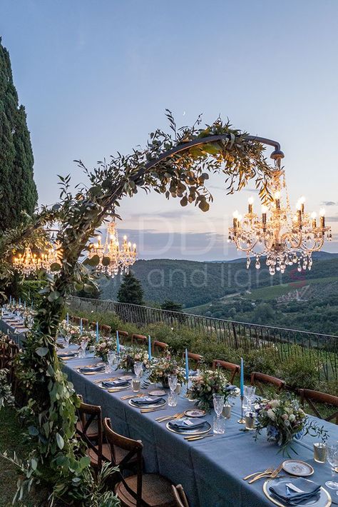 Crystal Chandeliers on Arch supports. Perfect for long tables! #weddingmusicandlights #weddingdecorationidea #weddinglighting Arch Chandelier Wedding, Arch Over Table Wedding, Arched Chandelier Wedding, Outside Chandelier Wedding, Over Table Arch, Arch With Chandelier Wedding, Chandelier Arch Wedding, Chandelier Over Table Wedding, Chandelier Wedding Arch