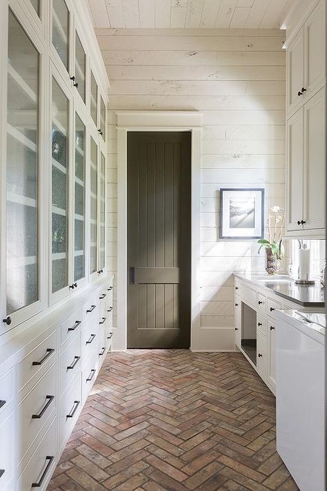 A red brick herringbone pantry floor boasts white drawers fitted with oil rubbed bronze hardware and positioned beneath stacked seeded glass cabinets. Brick Herringbone Floor, Kitchen Minecraft, Herringbone Brick Floor, Bloxburg Cottage, Wood Shiplap Wall, Elegant Cottage, Herringbone Brick, Brick Floors, Kitchen Bloxburg