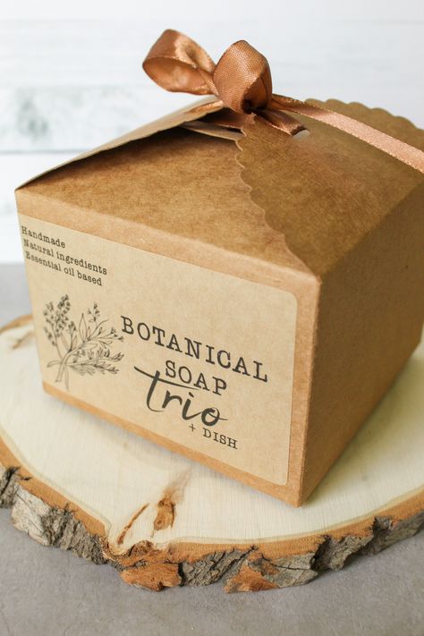 Make a lasting impression with this luxurious Soap Trio + Dish Gift Set. Pamper your loved one with all-natural, botanical soap bars that cleanse and nourish the skin. Featuring a trio of luxurious soaps and a handmade bamboo soap dish, this delightful gift set is sure to be appreciated! Why do we love this set? Palm free soap 100% natural products Variety of scents for your recipient Plastic free packaging Ingredients Hemsworth Homestead products are all-natural, made only with quality ingredie Bar Soap Packaging Design, Soap Box Design, Homestead Products, Soap Accessories, Luxury Soap Packaging, Natural Soap Packaging, Soap Boutique, Bar Soap Packaging, Packaging Ingredients