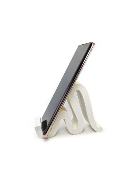 Curvy and modern cellphone and iPad stand in various colors. This cellphone holder perfectly holds iPhones and it is a stylish desk organizer. This item is very sturdy and strong. ● It is made of concrete. ● Color tone can be vary as this product is handmade. Pigments can be stronger in some spots which it is natural to all concrete products and makes each product unique. ● This stand is ideal for tablets and cellphones. ● This item is 100% handcrafted so imperfections, impurities and small irre Desk Cell Phone Holder, Pottery Phone Stand, Pottery Phone Holder, Ceramic Phone Stand, Cute Phone Stand, Phone Holder Clay, Ceramic Phone Holder, Phone Stand Design, Cellphone Stand