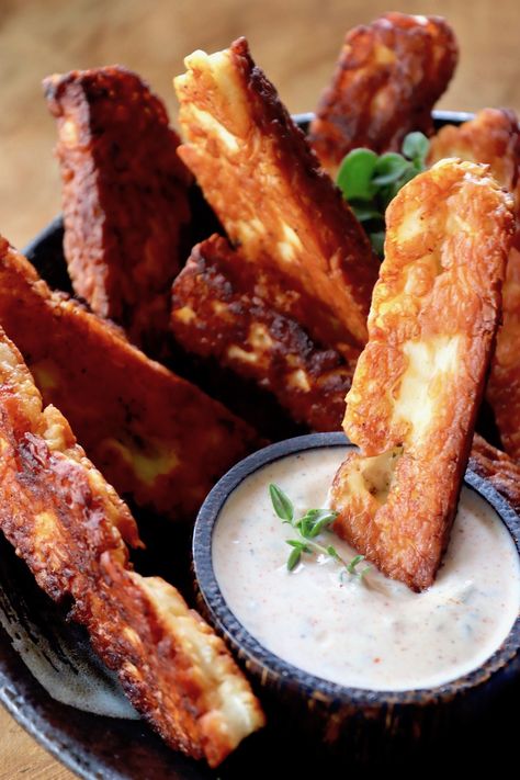 Halloumi Fries are an unexpected and absolutely scrumptious appetizer, snack or side dish. With an inherently tangy-salty flavor, they have a crispy caramelized crust and a soft and creamy interior. When you dip them in the sweet and spicy Greek yogurt dip, you might love them even more! #fries #halloumi #halloumifries #cheesefries #yougrtdip #Greekyogurtdip Halloumi Fries, Haloumi Cheese, Greek Fries, Vegetarian Party, Vegetarian Party Food, Fried Halloumi, Healthy Potato Recipes, Yogurt Dip, Meat Snacks