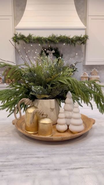 Ashley Savage | Creator | Atlanta, GA on Instagram: "🎄Christmas Kitchen Centerpiece🎄comment SHOP to get everything sent to your inbox! I know it is early, but these stems always sell out every year and they are currently on MAJOR sale, so I wanted to share!! I have been using these greenery stems for a couple years now and they are still my favorite! The light up branches are a fun touch and look beautiful at night. This Christmas centerpiece idea that would be so cute on your kitchen island for the holiday season! • • • #ltkholiday #ltkhome #christmasdecor #christmastree #christmascenterpiece #christmasideas #christmasdiy #christmasdecorating #christmastable #christmasgreenery #kitchencenterpiece #kitchenisland #kitchendecor #coffeetabledecor" Christmas Stool Decorations, Christmas Pitcher Decor, Kitchen Christmas Centerpiece, Christmas Mixing Bowl Decor, Large Table Christmas Centerpiece, Winter Island Centerpiece, Christmas Counter Centerpiece, Ginger Jars Christmas Decor, Round Table Christmas Centerpiece Ideas