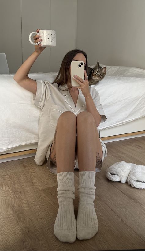 Girl taking a mirror picture of herself and her cat while wearing a beige linen summer set, comfy socks and fluffy slippers, holding a coffee cup over her head in a neutral and minimal bedroom with wood floors. Content Inspiration, Camille Styles, Morning Vibes, Yearly Goals, Dog Mama, Cat Aesthetic, Linen Set, My Cat, Cat Mom