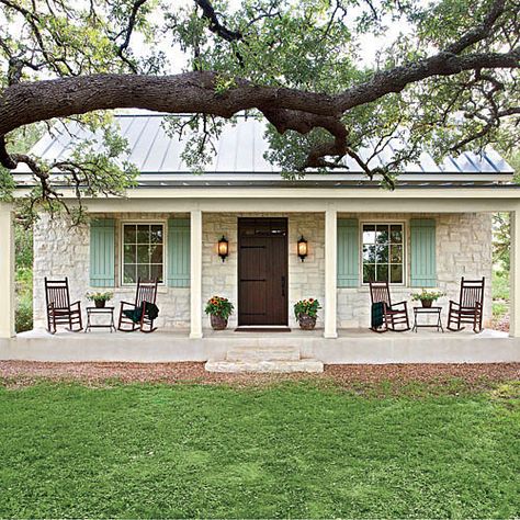 This casual Hill Country cottage pours on the Southern charm with its familiar farmhouse form, picture-perfect proportions, and inviting front porch nestled beneath a curtain of large oak trees. The stone facade and metal roofing nod back to Fredericksburg's original German-style architecture. We'd love to kick up our feet and wind down our week in this soulful country home. Texas Farmhouse, Farmhouse Front Porches, Stone Facade, Small Farmhouse, Farmhouse Front, Hus Inspiration, Farmhouse Cottage, घर की सजावट, Rocking Chairs