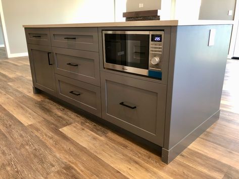 Another simple (but unique) feature of the 63 Mackenzie house is the microwave within the kitchen island. Benefits: 1) A microwave in a kitchen island can allow you to add an exhaust fan above your cooking stove. 2) You can save some space on counter tops or on top of islands if your microwave is inside the island. 3) It will ensure that your upper cabinet design looks sleek and has a sense of uniformity to it. Kitchen Island Microwave Shelf, Small Kitchen Stove In Island, Microwave Shelf In Island, Microwave In Counter Cabinet, Microwave At End Of Island, Microwave Under Island, In Drawer Microwave, Microwave Above Dishwasher, Stove On The Island