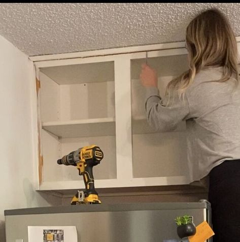 You know those cabinets over your fridge? You know, the ones you can't reach so you just store random stuff in there and forget about it. Or you just keep them empty. Yeah, you know the ones. These: There has been absolutely nothing in these cabinets since we bought this house 2 years ago. SOOOO- Let's take it down, shall we? Step 1: Remove cabinet doors Go ahead and take those useless doors off. We wont be needing them. Step 2: Remove screws Remove all screws that are attaching th… Taking Doors Off Cabinets, No Doors On Kitchen Cabinets, Open Cabinet Above Fridge, Taking Cabinet Doors Off In Kitchen, How To Take Down Cabinets, Take Doors Off Kitchen Cabinets, Remove Cabinet Doors Open Shelving, Taking Doors Off Kitchen Cabinets, Removing Cabinet Doors For Open Shelving