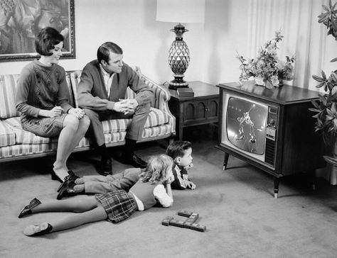 Slide 23 of 28: Older baby boomers might remember having to change TV channels by walking up and using the knobs, before remotes were common in every household. Kids Lying, Baby Boomers Generation, William Eggleston, Martin Parr, Salford, Vintage Memory, Foto Vintage, People Sitting, Watching Tv