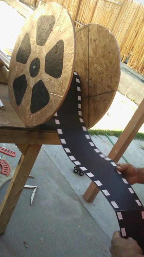 Movie reel guest book Film Decor Diy Movie Reels, Diy Movie Reel Decor, Movie Theme Float Ideas, Disney Movie Decorations, Movie Reels Decor, Hollywood Decorations Diy, Hollywood Parade Float Ideas, Movie Themed Parade Floats, Hollywood Homecoming Float