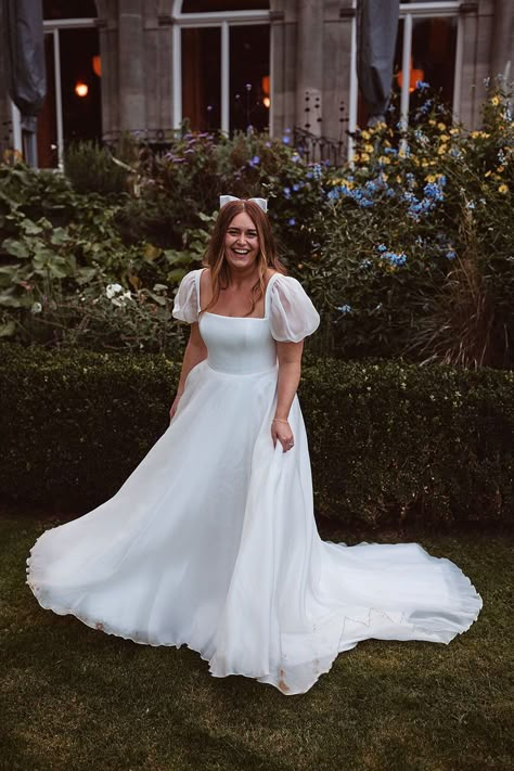 Real bride Sophie in Suzanne Neville Hailey wedding dress with custom sleeves for a Cowley Manor wedding. From Miss Bush bridal boutique Surrey. Worn with a satin hair bow by Gigi and Olive. Image © The Springles #missbush #suzanneneville #hailey #weddingdress #bridal #fashion #squareneck #corset #puffsleeves #hairbow #bow #bridalhair #accessories #styling Puffy Arm Wedding Dress, Plus Size Puff Sleeve Wedding Dress, Square Neck Puff Sleeve Wedding Dress, Milkmaid Wedding Dress, Bubble Sleeve Wedding Dress, Bridgerton Style Wedding, Wedding Dress Puff Sleeves, Cowley Manor, Bridgerton Inspired Wedding