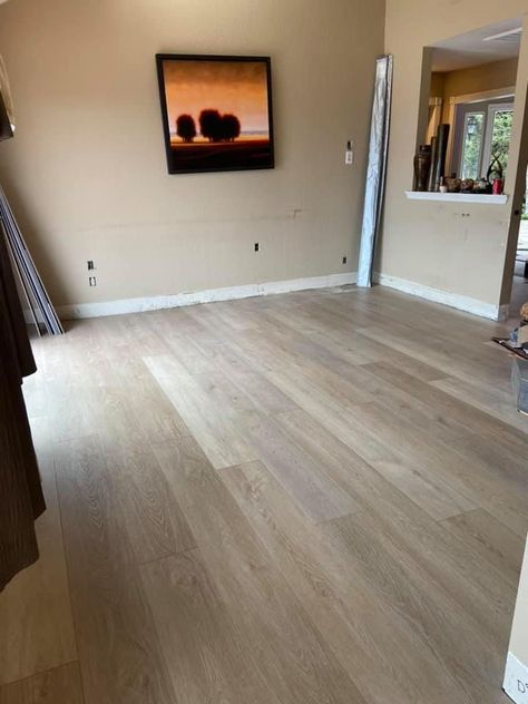 Living room space with cooler lighting featuring an install of Chateau by Paradigm Conquest. Even under cooler lighting the warmth of the plank still comes through as it's not washed out as easily as gold tones which are sensitive to cool ranges of light. Find more info in our online catalog or stop in and browse samples in store! Sunroom Flooring, Lvp Flooring, Waterproof Flooring, Living Room Spaces, Vinyl Plank Flooring, Plank Flooring, House Flooring, Cool Lighting, White Oak