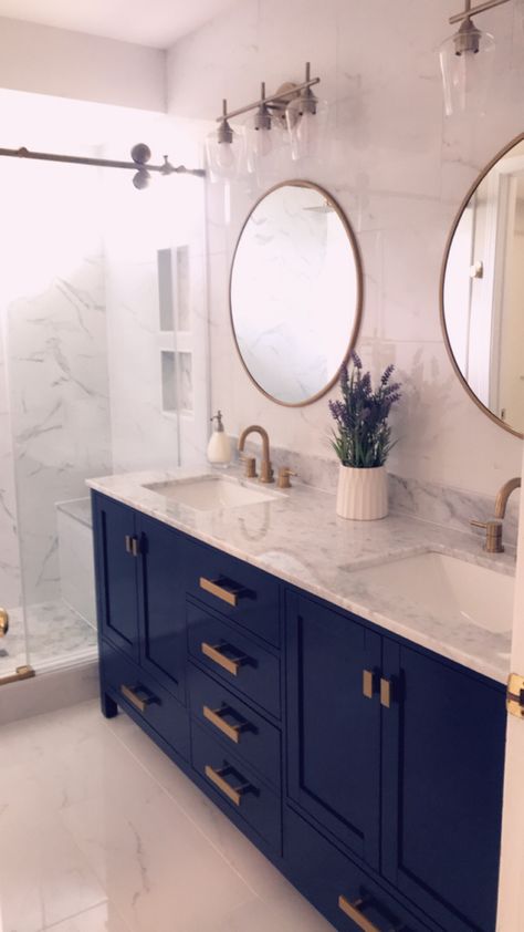 Valentino vanity blue and gold design with carrara marble top. Bathroom lights from wayfair. Faucets from floor and decor. Navy And Gold Ensuite, Navy Bathroom Vanity With Gold Hardware, Small Bathroom Remodel Blue Vanity, Colored Vanities Bathroom, Black Gold And Blue Bathroom, Coastal Bathroom Blue Vanity, Blue Gold And Wood Bathroom, Navy Marble Bathroom, Modern Blue Bathroom Design