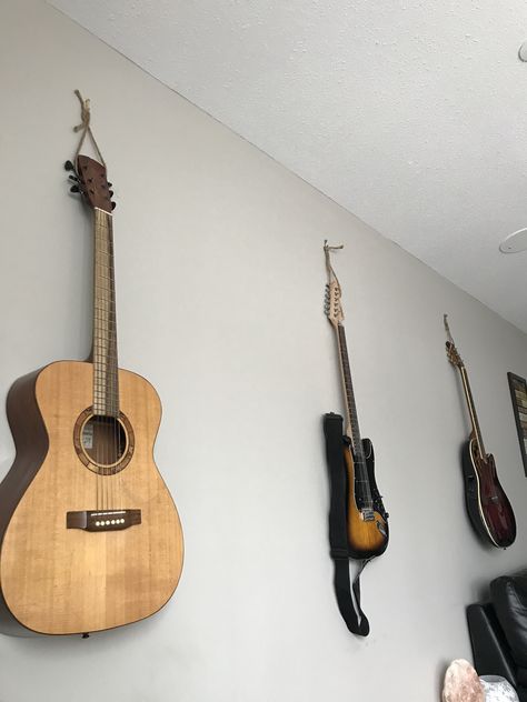 Lacking floor space? Try this #easy guitar hanging #hack . I live with my musically inclined sister who tends to leave her instruments all over the house. With a little jute twine, a few picture nails and some empty wall space I created happiness in the form of quick access for her and everything off the floor for me. #diy #guitar #spacesaving #cleanup #hangingguitar #musician #homedecor #budget #decor #declutter Ways To Hang Guitars On Wall, Hanging Guitars On Wall Ideas, Hang Guitar On Wall, Guitars On Wall, Instruments Diy, Hanging Guitars, Music Instruments Diy, Music Party Decorations, Guitar Hook