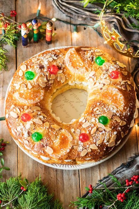 Learn how to make roscón de reyes, a traditional Spanish Epiphany bread, with this easy recipe. This orange-flavored yeast bread is decorated with dried fruit and nuts, and is eaten on Día de los Reyes Magos. If you find the Jesus figurine inside, you'll be king for the day! Spain Dishes, Kings Bread, Candied Orange Slices, Spanish Foods, Cinnamon Crunch, Pearl Sugar, Glace Cherries, Chantilly Cream, Food Appetizers