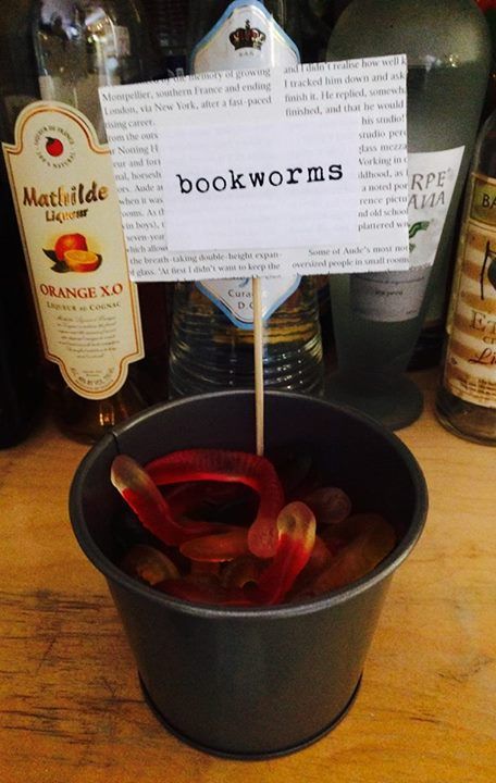 Book-themed gummis on the bar Romance Novel Themed Party, Book Themed Appetizers, Literary Dinner Party, Literary Festival Decor, Halloween Themed Book Club, Book Lover Party Ideas, Spooky Book Club Party, Book Dinner Party, Book Themed Hen Party