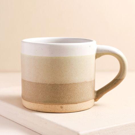 A neutral earth-tone mug in tones of beige  	With a glazed and unglazed ceramic look  	Complete with a faded ombre-design style  	Ideal gift for a lover of neutral kitchenware     Product Information    Treat yourself to a morning coffee in style with this ceramic ombre mug in beige tones.    This compact mug is complete with an ombre, natural design alongside a strip of unglazed ceramic for a rustic texture. Perfect for an evening tea to end the day, this mug will look stunning with any interio Neutral Kitchenware, Kitchenware Products, Mum Mug, Travel Coffee Cup, Rustic Texture, Ombre Design, Ombre Fashion, Green Mugs, Beige Tones