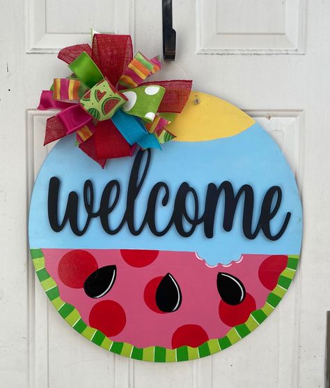 Such an adorable way to decorate for Spring or Summer, it will come with a Spring Summer Bow.  Bow patterns and style may change cased on what is available but will be in the same color scheme to match the door hanger accordingly.   . This 22 inch circle is hand painted and clear coated for longer use and protection. Spring/summer Doorhangers, Circle Door Hangers Wooden Diy Summer, Spring Summer Door Hangers, Watermelon Door Hanger Diy, Summer Welcome Sign Door Hangers, Door Sign Painting Ideas, Watermelon Welcome Sign, Round Door Signs Summer, May Door Hanger