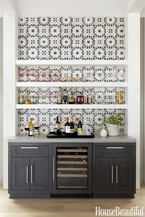 Opt for graphic tiles: Cement tiles from Ann Sacks, installed behind the Thermador gas cooktop and the dry bar beside the dining table, add the right amount of focal-point pattern. Click through for more amazing photos of this farmhouse kitchen. Black, Wine Rack, Wine, Bar, Black And White, Wall, White