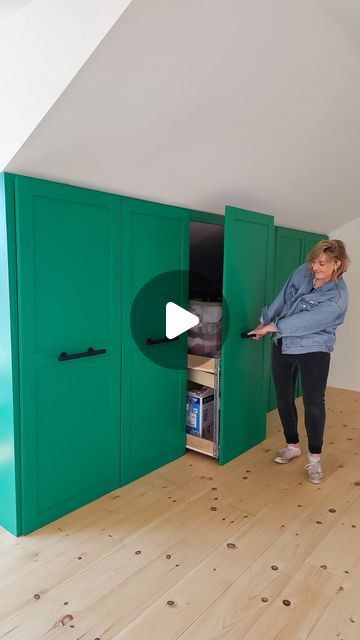 Danie Berger on Instagram: "Is this the ultimate solution for slanted wall storage? 😍 Not only do I now have more storage than I ever imagined, but it’s also stylish, colorful, and accessible from both sides!   I’m blown away by how much this 6-door, two-tier pull-out cart holds. I’ve had this idea in mind for ages, and seeing it come to life in my studio feels like a dream.   The best part? I didn’t have to break the bank to create a fully custom system. This has been the perfect way to maximize my space, and I hope it sparks some inspiration for your own projects too!  Also…does this green bring you as much joy as it brings me? It was the perfect colour choice.   🟢Exquisite Emerald P420-6, Behr   Love your magic! ✨  #storage #storagesolutions #storageideas #slantedceiling #smallspaces Slanted Wall Storage Ideas, Ideas For Slanted Walls In Bedroom, Sloped Wall Storage Ideas, Dormer Storage Ideas, Attic Eaves Storage Ideas, Vaulted Ceiling Storage Ideas, Vaulted Ceiling Storage, Deep Wardrobe Storage Ideas, Small Attic Room Ideas Slanted Walls