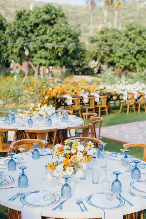 A custom jean jacket for the bride, lush pop of orange florals, a chic something blue wedding design, and dreamy views of the Mexican countryside came together perfectly for Maggie & Jeremy's I-DOs at Flora Farms in San Jose Del Cabo. We love how Amy Abbott Weddings & Events, Gideon Photography, and Pina Hernandez brought the day together. August Themed Wedding, Spaniard Wedding Theme, Blue Yellow And Orange Wedding, Light Yellow And Light Blue Wedding, Green Yellow Blue Wedding, Yellow And Blue Themed Wedding, Blue And Orange Wedding Decor, Blue Green Yellow Wedding, Nantucket Wedding Aesthetic