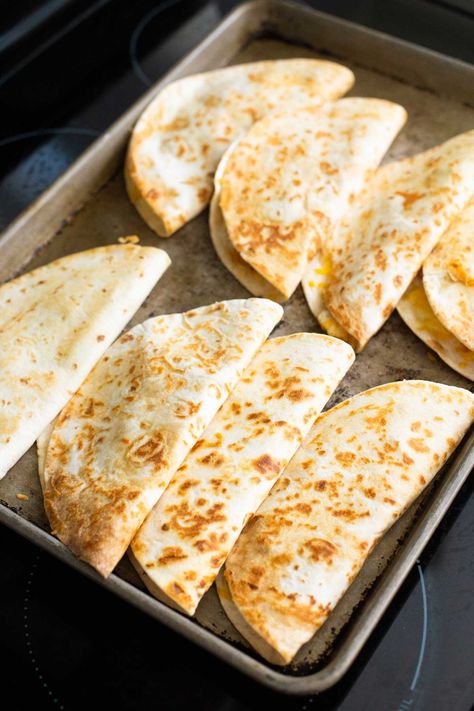 How to Cook Quesadillas Family-Style Different Kinds Of Quesadillas, Quesadilla Recipes For A Crowd, Stove Top Quesadilla, Quesadilla Recipes Oven Baked, Baked Cheese Quesadilla Oven, Taco Shell Recipe Ideas, Sheet Pan Chicken Quesadilla Recipes, Make Ahead Quesadillas, Sheet Pan Cheese Quesadillas