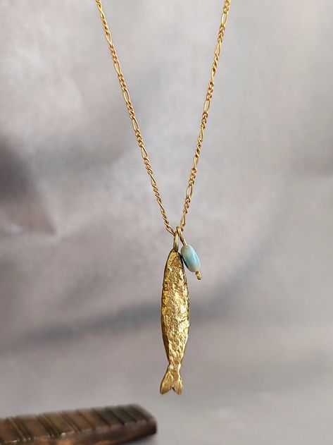 Necklace details:  * The necklace and the pendant made from 14 karats solid yellow gold. * Chain length 20Inch/ 50cm'. * Fish pendant size: 1.3x0.25inch/ 33x6mm. A goldfish necklace with the good eye stone that will lead us on the right path . Chain available in all sizes, color gold and karat and matte or shining finish. Each pendant is custom-made, unique, and will have slight variations in shape. If you want to change something, width, Length, personal engraving, or anything else. Please cont Fish Necklace Gold, Fish Pendant Gold, Goldfish Necklace, Snail Necklace, Gold Fish Necklace, Fish Jewelry, Fish Necklace, Fish Pendant, Gold Fish