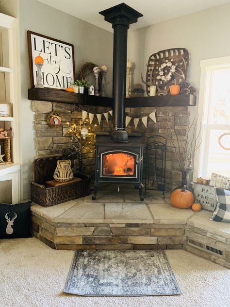 #woodstove #homedecor #cornermantle #farmhouse #fall #falldecor #mountains Raised Woodstoves, Woodstove Mantle Decor, Wood Stove Area Ideas, Wood Burning Stove Corner Farmhouse, River Rock Wood Stove Surround, Wood Stove Hearth Ideas Farmhouse, Pellet Stove Hearth Ideas, Wood Stove Mantle, Woodstove Mantle