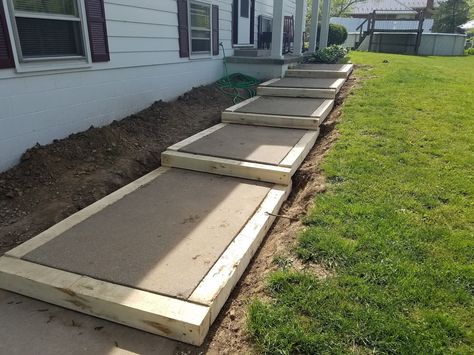 Building a side walk, building a walk on a slope, DIY sidewalk, using salvaged items to frame a walk. Sidewalk On A Slope, Diy Side Walk Walkways, Front Sidewalk Ideas, Pallet Decks, Diy Sidewalk, Side Walkway, Landscape Stairs, Concrete Path, Landscape Steps