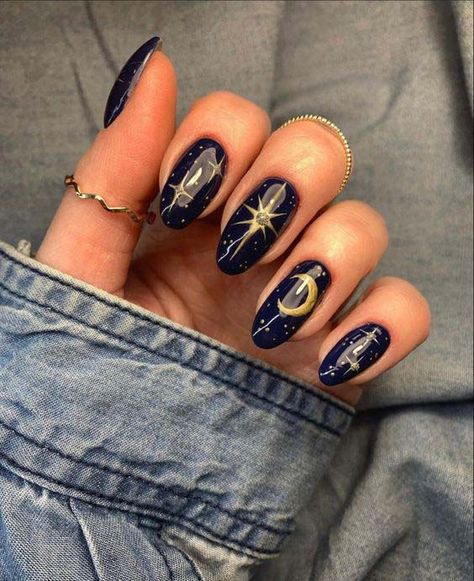 16. Black Nail Background With Gold Stars And Moon #blacknails #beauty #trendypins Navy Blue Celestial Nails, Nails With Moons And Stars, Celestial Almond Nails, Acrylic Nail Designs Goth, Black Nails With Moon, Black Moon Nails, Navy Blue Nails With Gold, Moon Phase Nails, Nail Art Black And Gold