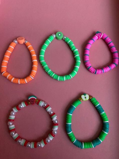 5 fruit clay bead bracelets  Orange and white🍊 Kiwi, green and white🥝 Strawberry, pink and green🍓 Watermelon, red, white, green and pearls🍉 Apple, green, and white 🍏 Kiwi Bracelet, Fruit Bracelets, Bracelets Orange, Fruit Bracelet, Clay Bead Bracelets, Fruit Orange, Green Watermelon, White Strawberry, Strawberry Pink