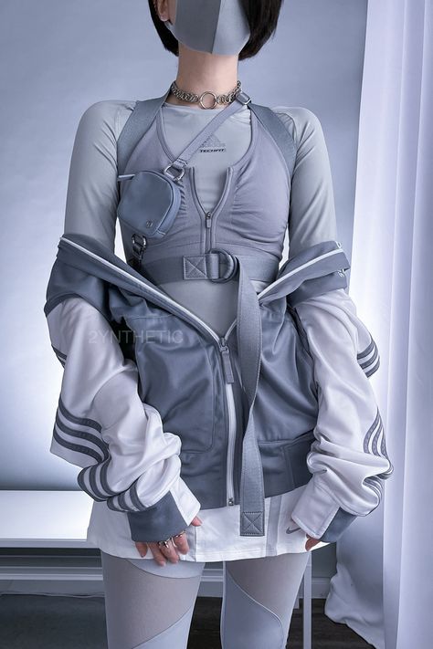 A person with short black hair is standing and wearing an all grey techwear outfit, with a white and grey Adidas track jacket. Cool Techwear Outfits, Alt Futuristic Outfits, Feminine Cyberpunk Outfit, Future Aesthetic Outfit, Outfit Ideas Futuristic, Futuristic Casual Fashion, Cyberpunk Outfit Inspiration, Blue Techwear Outfit, Korean Futuristic Fashion