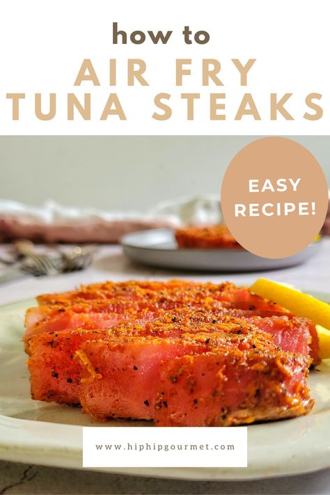 sliced seasoned tuna steak on a plate with a lemon, another in the background Ways To Cook Tuna Steak, How To Prepare Tuna Steaks, Airfryer Tuna Steak, Tuna Steak Air Fryer Recipes, Ahi Tuna Air Fryer, Air Fry Tuna Steak, Tuna In Air Fryer, Ahi Tuna Steak Recipe Air Fryer, Air Fryer Ahi Tuna Steak