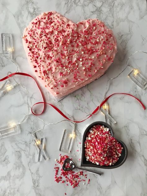 This post contains affiliate links.A heart shaped cake for Valentine’s Day or any day is easy and delicious and takes no many pans, only a standard 9″ round and 9″ square pan. Good afternoon friends, this weekend is not only Valentine’s Day but it is going to be a cold, icy and snowy weekend, the perfect time to be in the kitchen baking. I love baking on cold, winter days, the sweet sugar scent of a cake or cookies wafting in the air and the anticipation of a tasty warm treat to com… White Almond Cakes, Heart Shaped Cake Pan, Butter Cream Frosting, Heart Shaped Cake, Decorator Frosting, White Cake Recipe, Valentine Day Cupcakes, Square Cake Pans, Filled Cupcakes