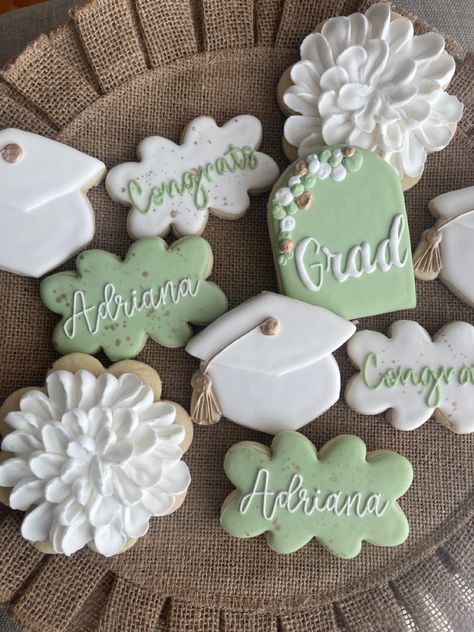 70s Graduation Party Ideas, Floral Grad Cookies, Graduation Party Ideas Sage Green, Flower Graduation Cookies, College Themed Graduation Party, Green White And Gold Graduation Party, Sage Green Gold And White Graduation Party, Sage Green Grad Party Decor, Graduation Party Ideas Aesthetic Green