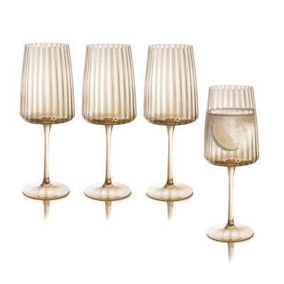 Raise a toast to your luxe home setting with this Orlosky All Purpose Wine Glass Set. It features the unique ripple effect while hosting a festive party or enjoying your drink. Color: Amber | Latitude Run® Orlosky Amber All Purpose Wine Glasses, Set / 4 Glass in Brown | 9.75 H in | Wayfair Cocktail Glassware Set, Kitchen Cups Glasses, Glassware Table Settings, Modern Drinking Glasses, Gold Wine Glasses, Juice Glass Set, Elegant Glassware, Colored Wine Glasses, College Things