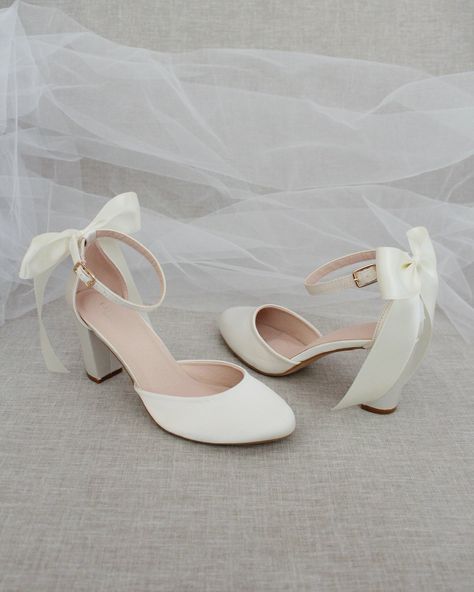 An all-time classic and elegant style with simplicity of satin heels with a satin back bow. DETAILS:HEEL HEIGHT: 3 inchesCOLORS AVAILABLE: Champagne, White, Ivory, Navy, Burgundy, and Light BlueUPPER: Synthetic upper and liningMATERIALS: Mandmade outsoleSTYLE NAME: SARAH Light Blue Heels With Bow, Wedding Flats With Bow, White High Heels With Bows, Bride Shoes Short Heel, Two Inch Heels, White Heels Elegant, White Prom Shoes Low Heels, Ivory Satin Heels, Heels With Bows On Back