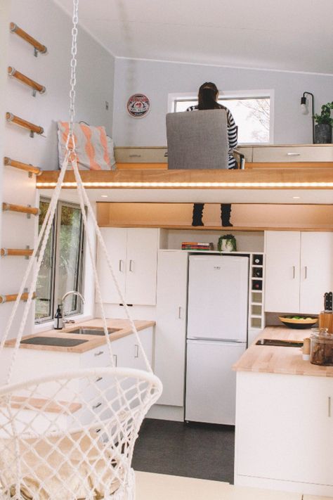 A wall ladder provides access to an office loft with built-in desk attached to the wall. A foot-well drops down to a shelf in the kitchen below to allow you to sit comfortably on the floor. Loft Stairs Ideas, Shelf In The Kitchen, Design Casa Piccola, Små Rum Lidt Plads, Office Loft, Wall Ladder, Tiny Home Office, Wohne Im Tiny House, Tiny Loft