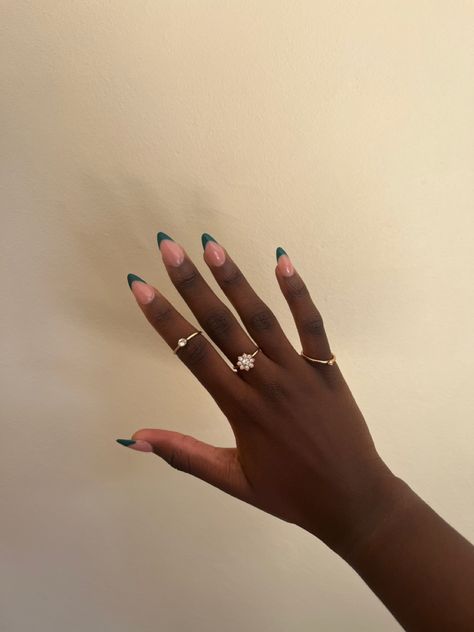 black girl hands and green French tips, almond shaped with golden rings Emerald Green French Tip Nails Almond, Dark Green French Nails, Emerald Nails Acrylic, Colour French Tips Nails, Dark Green French Tip, Dark Green French Tip Nails, Green French Tip Nails, Green French Tips, Green French Tip