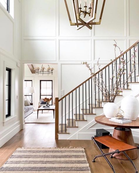 Crown Molding On High Ceilings, Modern Cozy Staircase, Paneling On Staircase, Open Staircase Accent Wall, Stair Ballister Ideas, Two Story Wainscoting, Paneling On Stairs, Foyer Molding Two Story, Wall Paneling Staircase