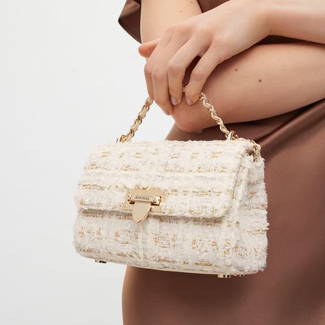 Miniature in size but mighty on style, our Micro Lottie Crossbody Bag in ivory tweed is designed to carry your barest of essentials. Handcrafted from full-grain leather, sophisticated tweed weaves together ivory and gold threads for a rich finish that brings a luxurious edge to any outfit ensemble.* Our best-selling silhouette in positively micro proportions boasts all the beautifully eye-catching detailing of the original, including our iconic letterbox closure and leather plaited metal chain. Tweed Bag Outfit, Aspinal Of London Bag, Tweed Outfit, Tweed Bag, Micro Bag, London Bags, Aspinal Of London, Signature Hardware, Money Bag