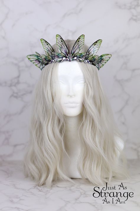 This is a must-have for all fairies! Here we have a beautiful tiara, fit for any fairy queen! This enchanting crown is comprised entirely of my handmade bright green fairy wings. The wings are attached a metal silver band, and adorned with clear gemstones. The wings are lightweight and far more durable than their glassy appearance might suggest! One size ought to fit all, but do message me if you are unsure. This tiara is best suited to adults over children, due to small parts. This is definitely a head turner! This beautiful crown is absolutely perfect for any fairy costumes and cosplays, Pagan or Wiccan events, weddings, proms - or even everyday wear. This would make the perfect addition to your festival outfit, bridal attire, renaissance costume ... the possibilities are truly endless. Green Fairy Wings, Faerie Costume, Clear Gemstones, Festival Crown, Fairy Headpiece, Fairy Costumes, Fairy Festival, Fairy Crown, Bridal Attire