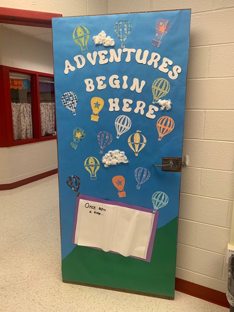 Classroom door decorated with blue background, a book that says, “once upon a time”, hot air balloons lifting up into the sky. The door says, “Adventures begin her”. Welcome Back To School Door Ideas, School Decorations Ideas Classroom Setup, Preschool Door Decorations, Beginning Of School Year, Decorate Classroom, Class Door Decorations, Preschool Door, Classroom Door Decor, Class Door