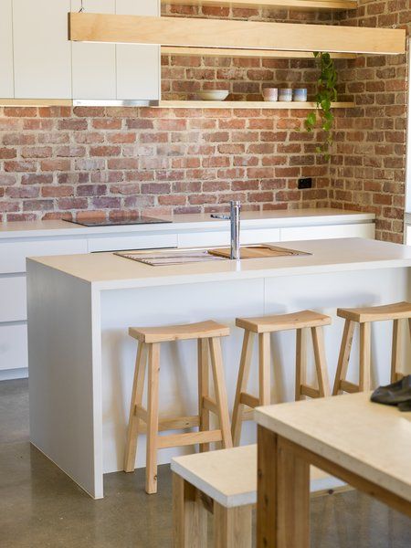 Kitchen, Cooktops, White Cabinet, Concrete Floor, Pendant Lighting, Drop In Sink, and Brick Backsplashe The kitchen stools are from Tuscan Outdoor Tables, a Dandenong, Victoria, outfit that crafts furniture from local Cypress and reclaimed timber. Tuscan Kitchens, Brick Backsplash Kitchen, Interior Brick, Brick Interior Wall, Kitchen Drawing, Brick Kitchen, Brick Backsplash, Drop In Sink, Tuscan Kitchen