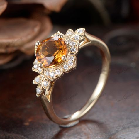 Similar item： https://www.etsy.com/listing/1763948733 This Unique Vintage Edwardian Citrine Ring is an exquisite piece of jewelry that beautifully combines historical elegance with modern sophistication. Crafted from 14K solid gold, the ring features a round-cut champagne citrine as its center stone, exuding a warm and captivating glow. The design includes intricate flower-de-luce motifs, characteristic of the Edwardian era, adding a touch of antique charm. As a solitaire ring, the focus remains Citrine Marquise Engagement Ring, Engagement Rings Topaz Yellow, Yellow Rings Stones, Citrine Engagement Rings, Yellow Topaz Jewelry, Yellow Stone Engagement Ring, Citrine Wedding Ring, Ring Redesign, Citrine Rings