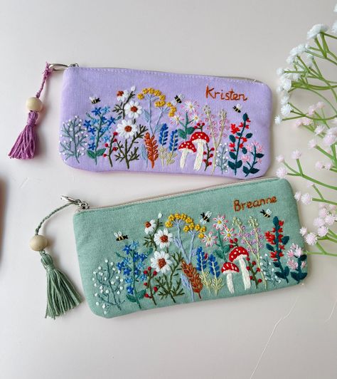 IF YOU NEED A PERSONALIZED DESIGN OR CUSTOM SIZE, PLEASE MESSAGE US. 📍 The pouch is embroidered with beautiful flowers, roses and can be customed your names, completely hand-embroidered from Vietnamese craftsmen.  - Material: soft linen combined with embroidery floss - Texture: embroidered flowers, mushroom and custom text.  - Size: 3.5x7.5" (9x19cm), 4.7x7.5" (12x19cm) The bag is not only pencil case but can be served as an everyday bag for your sunglasses, jewerly, coin purse. 📍  You buy thi Hand Embroidery Purse, Embroidery Bags Handmade, Linen Gifts, Embroidery Pouch, Embroidery Floss Crafts, Hand Embroidered Gifts, Handmade Makeup Bag, Embroidery Purse, Linen Pouch