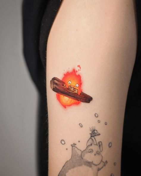 Deborah Genchi on Instagram: "As you loved it… a flaming Calcifer 🔥 becomes part of the collection! 😍 (The other black characters are not from me) @debrartattoos  #debrartist #debrartattoos #calcifer #miyazakitattoo #studioghiblitattoo" Calsifer Howl Tattoo, Studio Ghibli Calcifer Tattoo, Calsipher Tattoo, Howls Moving Castle Tattoo Calcifer, Calcifer Drawing, Studio Ghibli Calcifer, Calcifer Tattoo, Cooking Tattoo, Miyazaki Tattoo